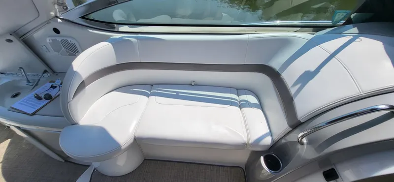 Slide: The Image of 2002 Formula 37 PC boat interior with white leather seating and cup holders. - 12