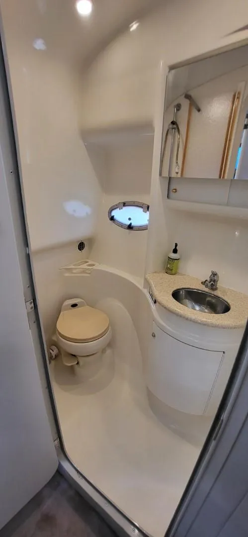Slide: The Image of 2002 Formula 37 PC boat bathroom with sink, toilet, and mirror. - 16