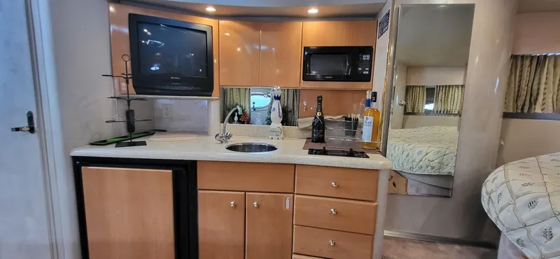Slide: The Image of 2002 Formula 37 PC yacht interior with kitchenette, TV, and microwave. - 19