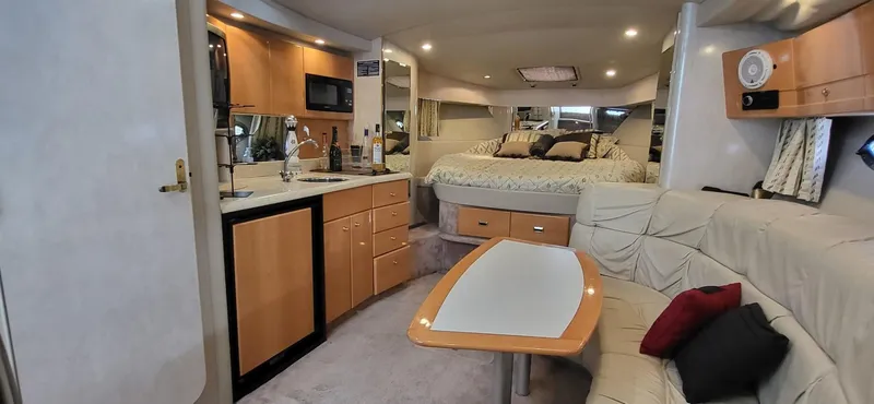 Slide: The Image of 2002 Formula 37 PC yacht interior with kitchen, seating area, and bed. - 20