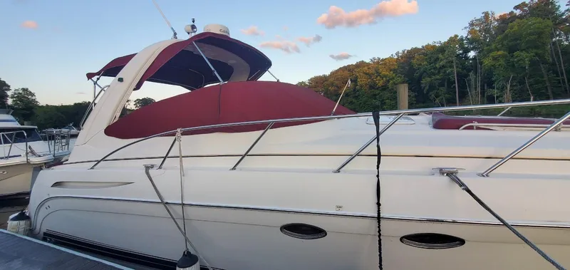 Slide: The Image of 2002 Formula 37 PC yacht docked with red canopy, surrounded by trees and blue sky. - 3