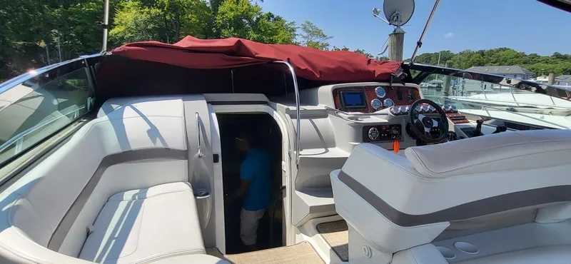 Slide: The Image of 2002 Formula 37 PC yacht interior with seating and control panel, docked outdoors. - 4