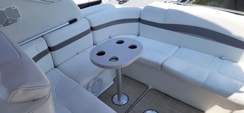 Slide: The Image of 2002 Formula 37 PC boat interior with white seating and round table. - 5