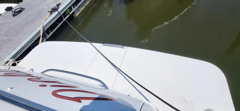 Slide: The Image of Rear view of a 2002 Formula 37 PC boat docked at a marina. - 7