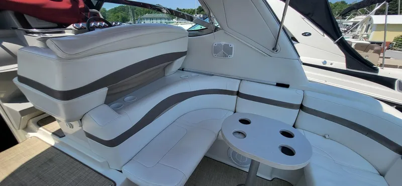 Slide: The Image of 2002 Formula 37 PC boat interior with white seating and round table. - 9