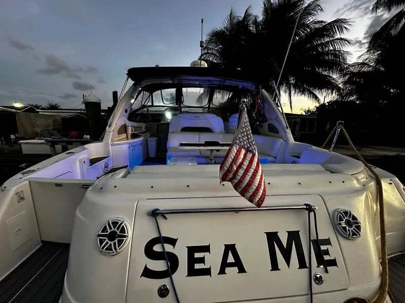 Slide: The Image of Sea Ray 460 Sundancer 2000 yacht with American flag at sunset. - 2