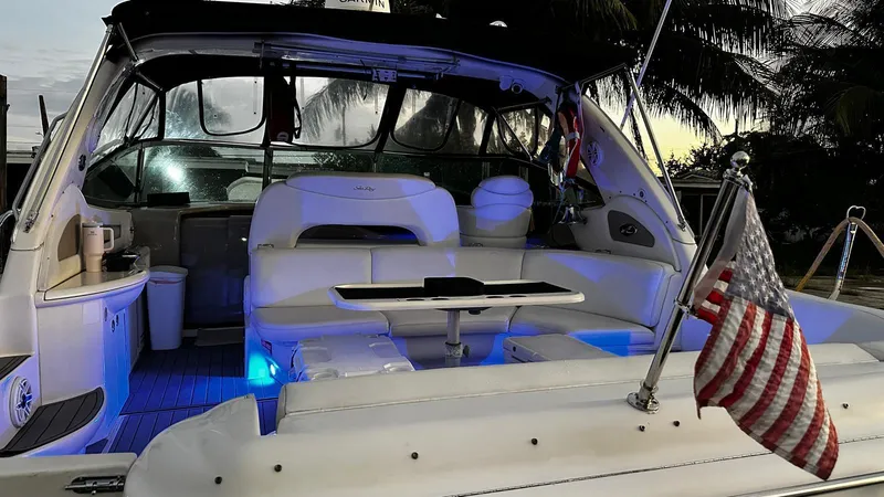 Slide: The Image of 2000 Sea Ray 460 Sundancer yacht with American flag, illuminated seating area. - 3