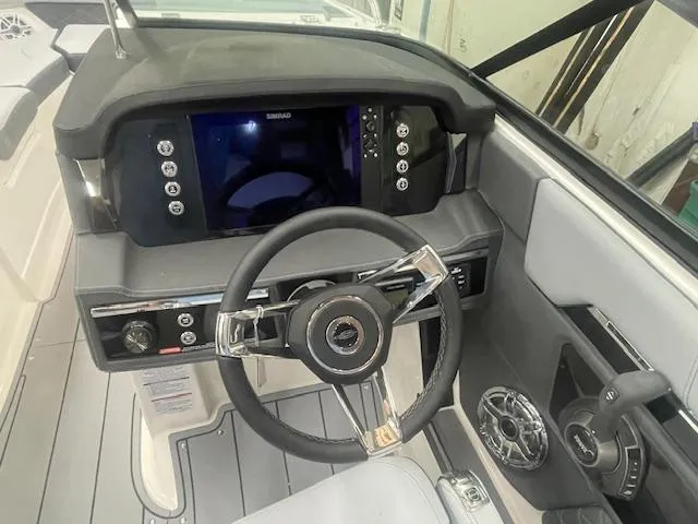 Slide: The Image of 2025 Chaparral 267 SSX boat interior with modern dashboard and steering wheel. - 10