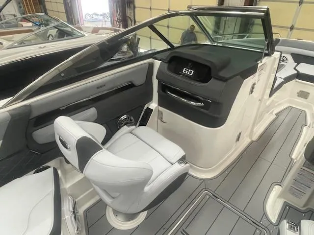 Slide: The Image of 2025 Chaparral 267 SSX boat dashboard with steering wheel and control panel. - 11