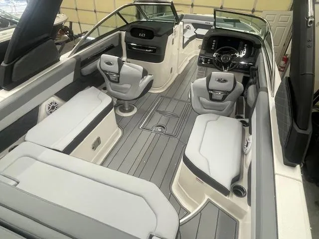 Slide: The Image of 2025 Chaparral 267 SSX boat on trailer in indoor storage facility. - 3