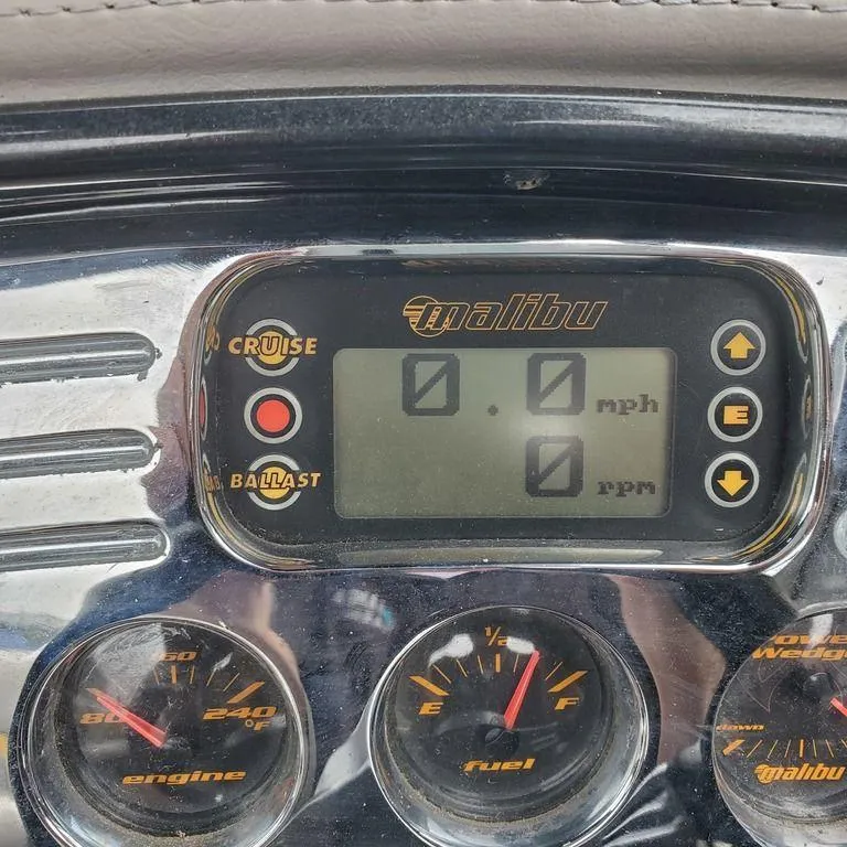 Slide: The Image of Dashboard of a 2006 Malibu 23 LSV boat showing speed and RPM gauges. - 11