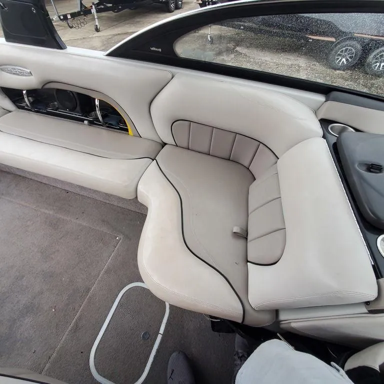 Slide: The Image of 2006 Malibu 23 LSV boat interior with beige seating and carpeted floor. - 7