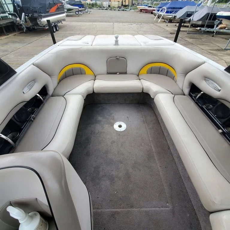Slide: The Image of 2006 Malibu 23 LSV boat interior with spacious seating and gray upholstery. - 8