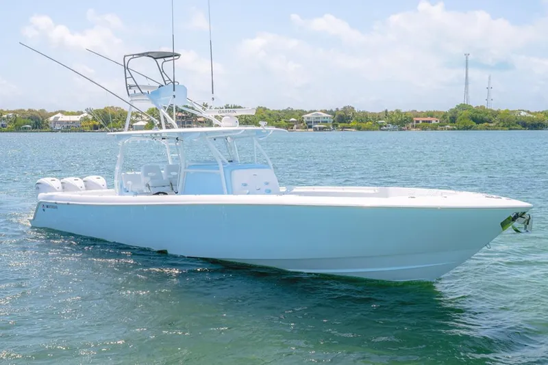 Slide: The Image of 2022 Contender 44ST boat on calm water, clear sky background. - 0