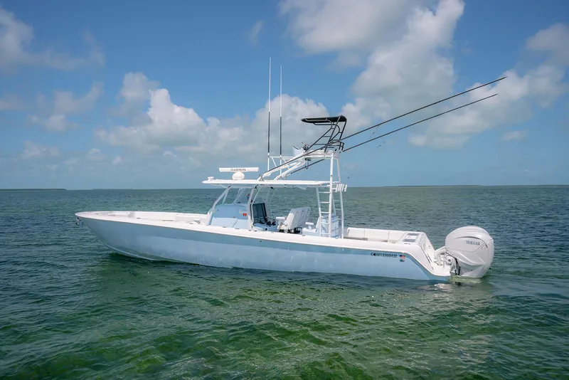 Slide: The Image of 2022 Contender 44ST boat on calm ocean waters under blue sky. - 1