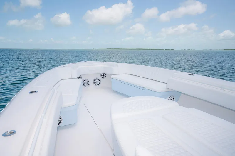 Slide: The Image of 2022 Contender 44ST boat on open water, featuring spacious seating and clear skies. - 13
