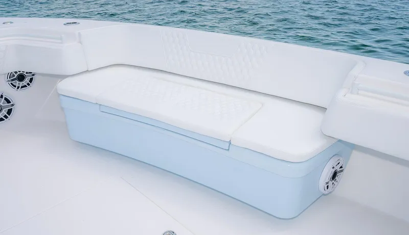 Slide: The Image of 2022 Contender 44ST boat with white cushioned seating and ocean backdrop. - 14