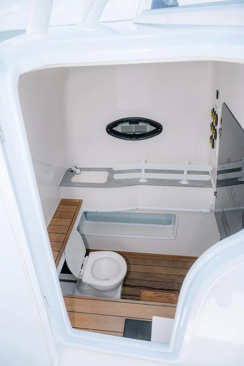 Slide: The Image of 2022 Contender 44ST boat interior with modern bathroom and wooden flooring. - 16