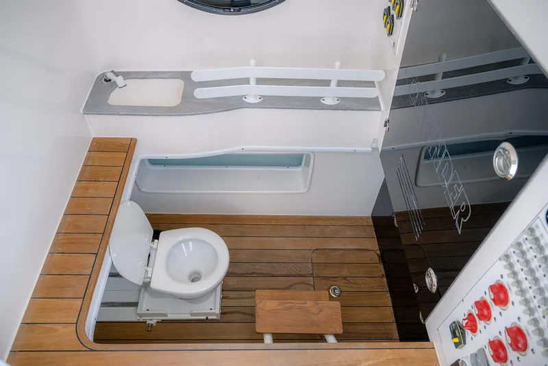 Slide: The Image of 2022 Contender 44ST boat bathroom with wooden flooring and modern fixtures. - 17