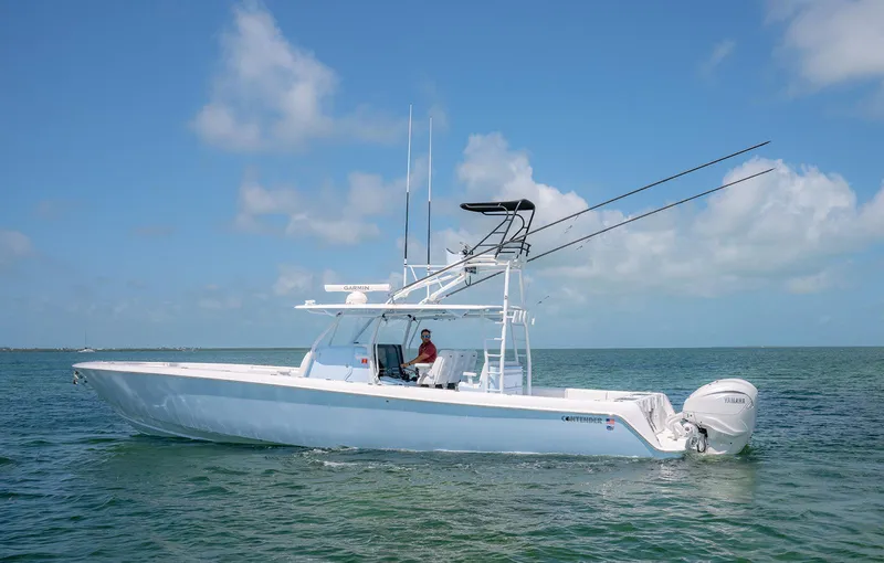 Slide: The Image of 2022 Contender 44ST boat on open water under clear blue sky. - 2