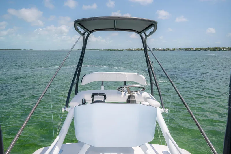 Slide: The Image of 2022 Contender 44ST boat on calm ocean waters under clear skies. - 25