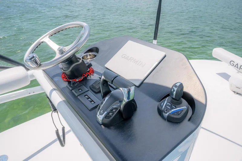 Slide: The Image of Contender 44ST 2022 boat helm with Garmin navigation and control systems. - 27