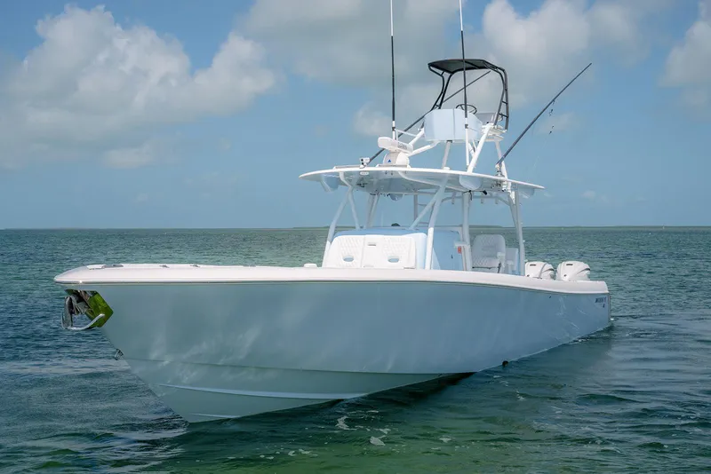 Slide: The Image of 2022 Contender 44ST boat on calm ocean waters under a clear sky. - 3