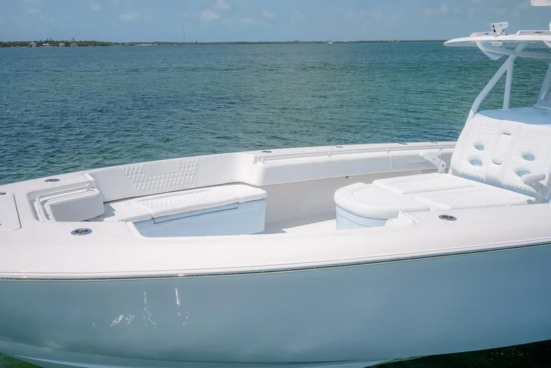 Slide: The Image of 2022 Contender 44ST boat on clear blue water, showcasing sleek design and spacious deck. - 4