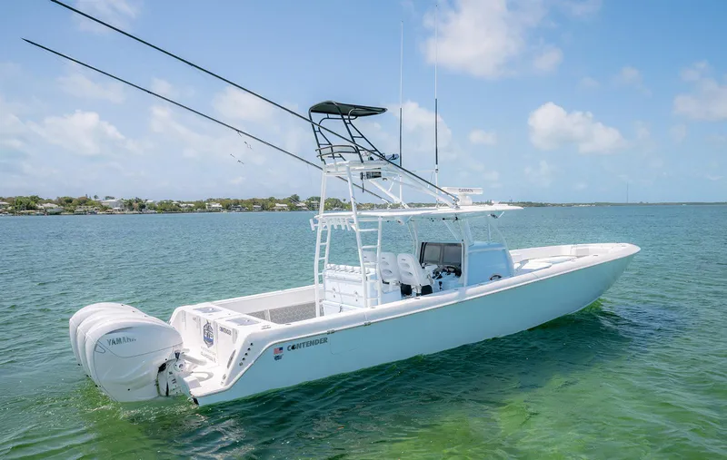 Slide: The Image of 2022 Contender 44ST boat on clear water with twin outboard engines. - 6