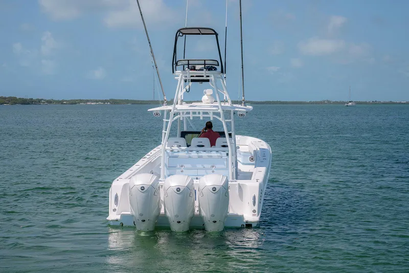 Slide: The Image of 2022 Contender 44ST boat with triple engines on calm water. - 7