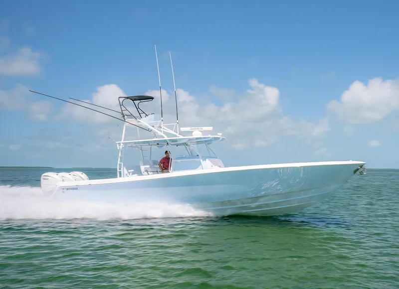 Slide: The Image of 2022 Contender 44ST boat speeding on open water under clear blue skies. - 8