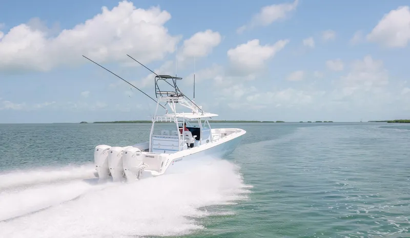 Slide: The Image of 2022 Contender 44ST boat speeding on open water under a clear sky. - 9