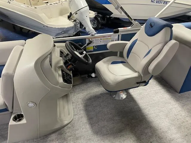 Slide: The Image of 2025 South Bay LE boat interior with captain's chair and steering console. - 10