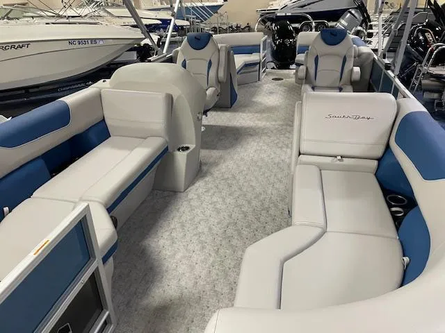 Slide: The Image of 2025 South Bay LE pontoon boat interior with blue and white seating. - 11