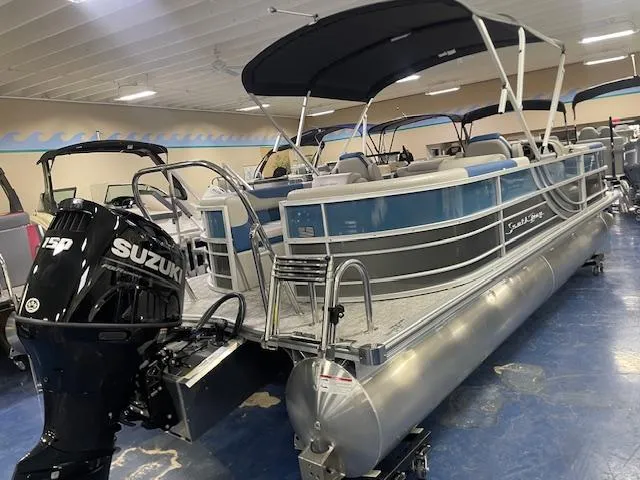 Slide: The Image of 2025 South Bay LE pontoon boat with Suzuki 150 engine in showroom. - 3