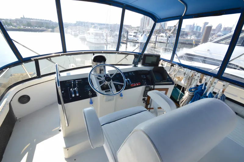 Slide: The Image of Interior of 1991 Carver 43 Cockpit Motoryacht helm with marina view. - 11