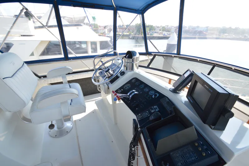 Slide: The Image of Interior helm of 1991 Carver 43 Cockpit Motoryacht with steering wheel and navigation equipment. - 13