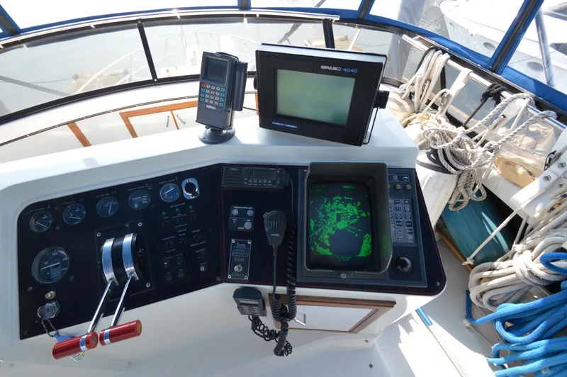 Slide: The Image of 1991 Carver 43 Cockpit Motoryacht helm with navigation equipment and controls. - 14