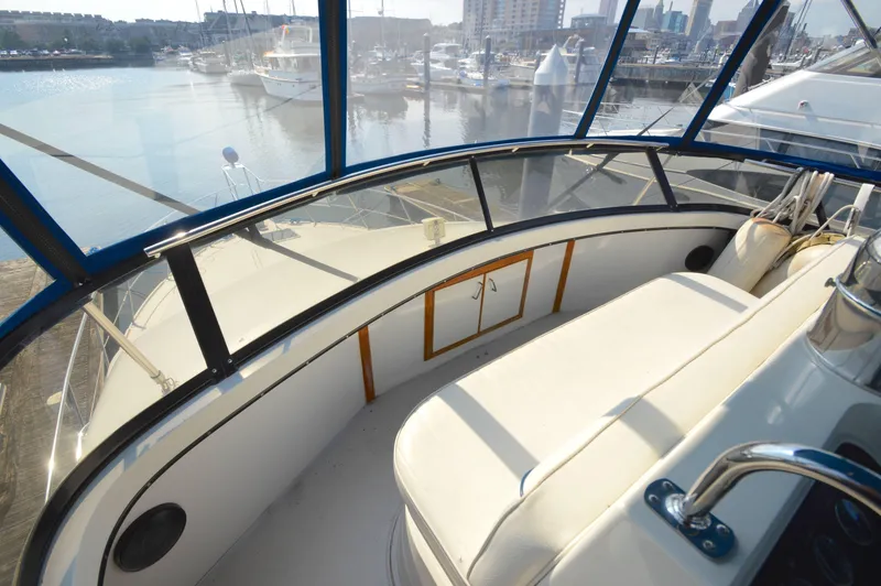 Slide: The Image of 1991 Carver 43 Cockpit Motoryacht interior with marina view, featuring seating and helm area. - 16