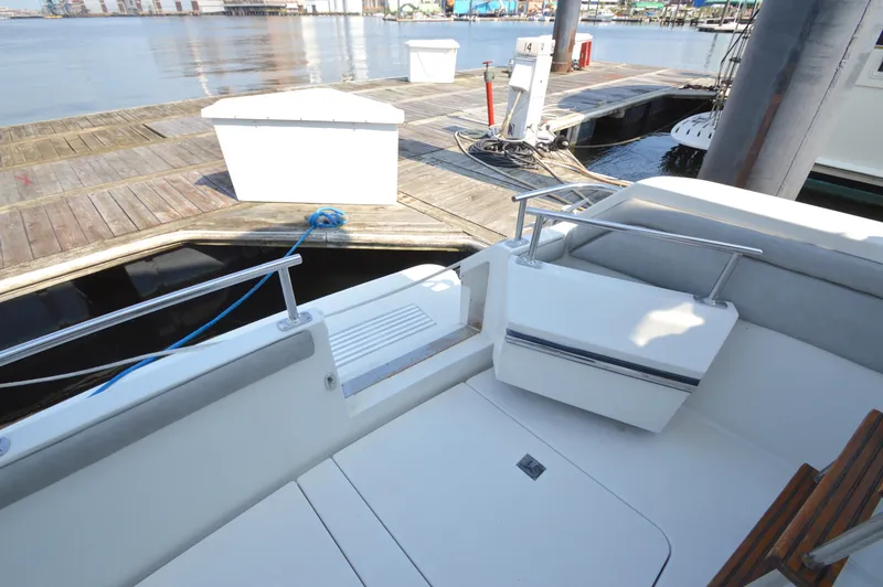 Slide: The Image of 1991 Carver 43 Cockpit Motoryacht docked at marina, featuring spacious seating area. - 18