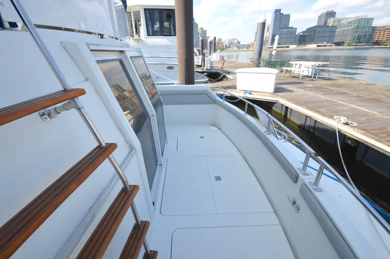 Slide: The Image of 1991 Carver 43 Cockpit Motoryacht docked, showcasing spacious deck and marina view. - 19