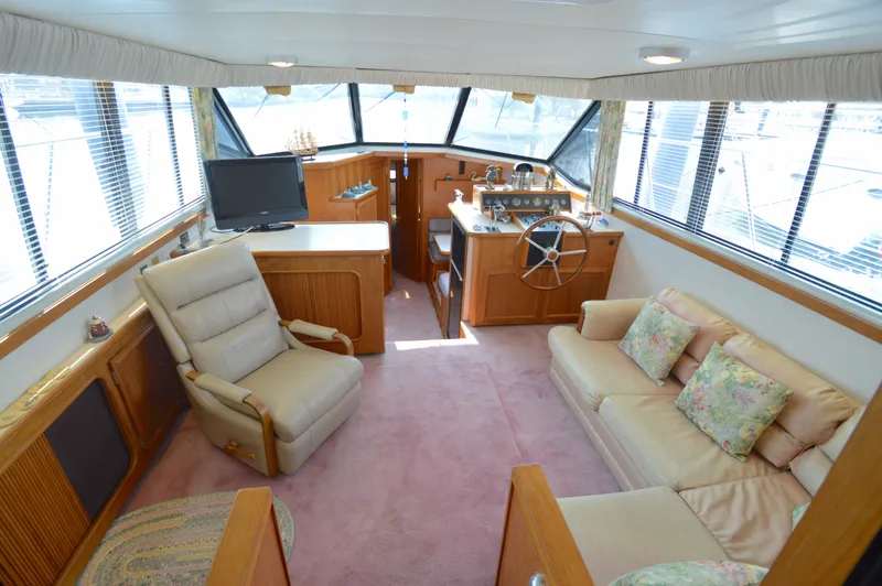 Slide: The Image of Interior of 1991 Carver 43 Cockpit Motoryacht with cozy seating and helm station. - 2