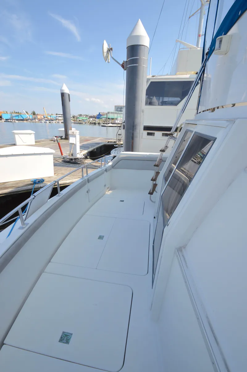 Slide: The Image of 1991 Carver 43 Cockpit Motoryacht docked, showcasing spacious deck and sleek design. - 20