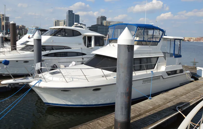 Slide: The Image of 1991 Carver 43 Cockpit Motoryacht docked at marina with city skyline. - 21