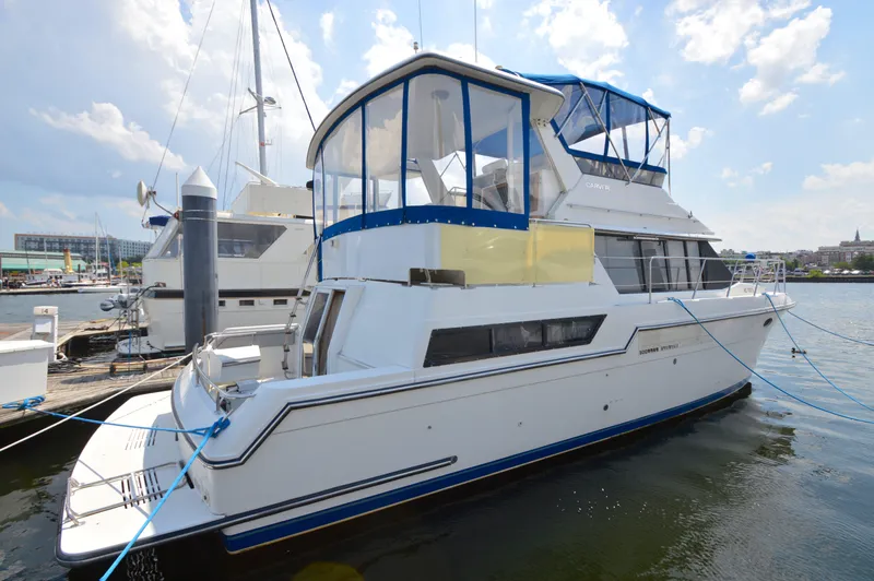 Slide: The Image of 1991 Carver 43 Cockpit Motoryacht docked at marina under blue sky. - 22