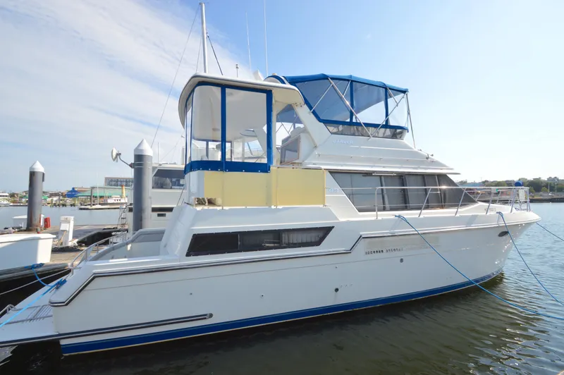 Slide: The Image of 1991 Carver 43 Cockpit Motoryacht docked at marina, side view. - 23