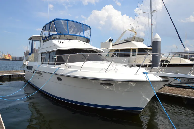 Slide: The Image of 1991 Carver 43 Cockpit Motoryacht docked at marina under blue sky. - 25