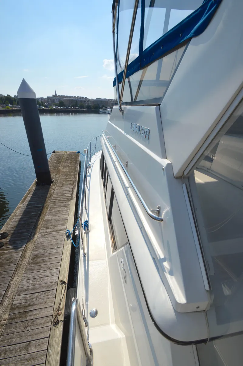 Slide: The Image of 1991 Carver 43 Cockpit Motoryacht docked at a marina, side view. - 26