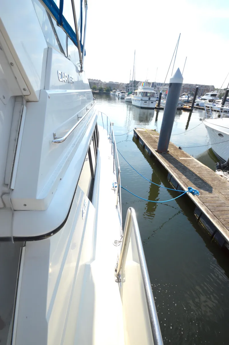 Slide: The Image of 1991 Carver 43 Cockpit Motoryacht docked in a marina, side view. - 27