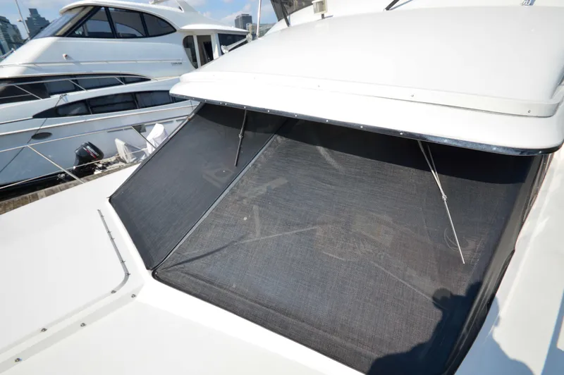 Slide: The Image of 1991 Carver 43 Cockpit Motoryacht with sunshade, docked alongside similar yachts. - 29